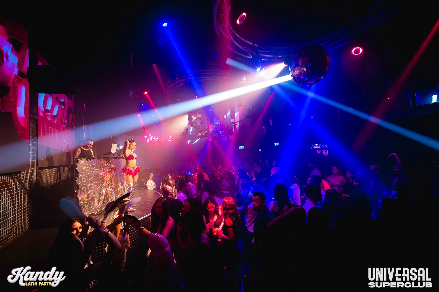 Packed Kandy dance floor under pink and blue lights